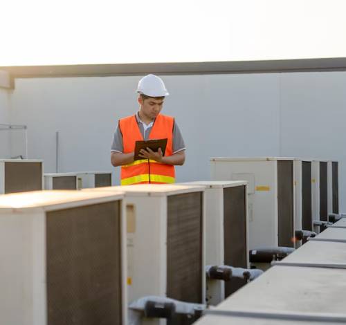 Air conditioning mechanic inspecting air Conditioners