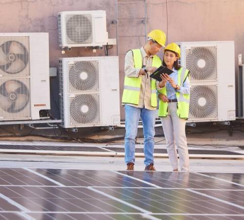 HVAC technicians checking air conditioners
