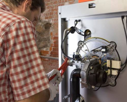 HVAC technicians repairing gas heater