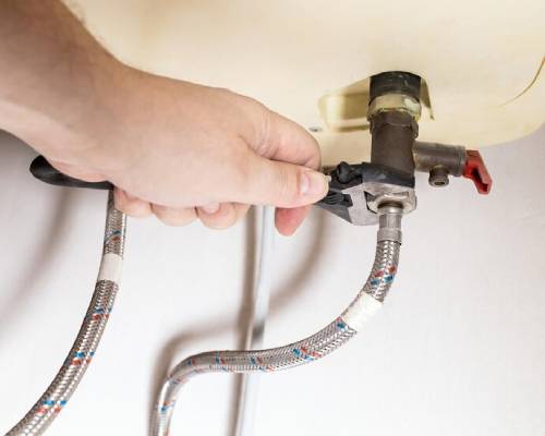 Professional technicians inspecting gas heater